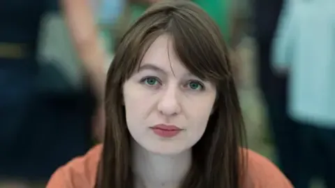 The acclaimed novelist declares she will not enter the UK due to arrest fears